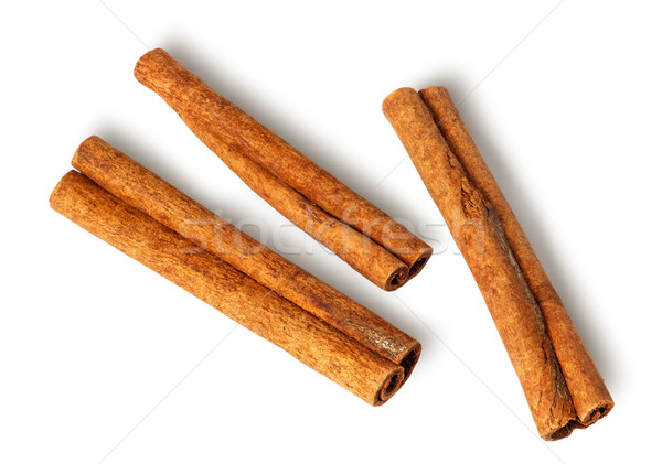 Three cinnamon sticks lie nearby Stock photo © Cipariss