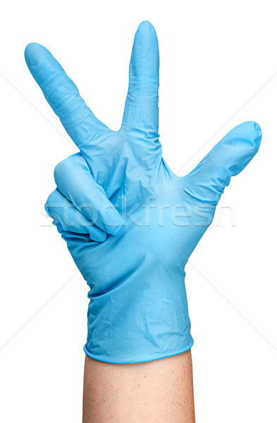 Hand in blue latex glove showing three fingers vertically Stock photo © Cipariss