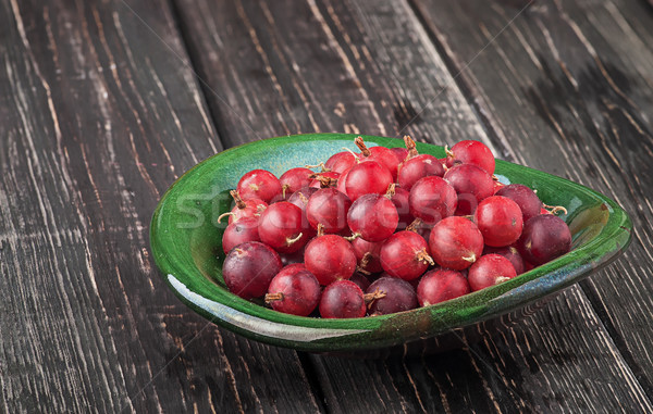 Red gooseberry in clay bowl Stock photo © Cipariss