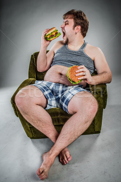 Foto stock: Homem · gordo · alimentação · hambúrguer · poltrona · estilo