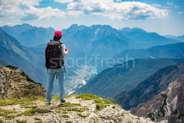 Hiker woman standing up achieving the top Dolomites Alps. Stock photo © cookelma