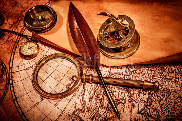 Vintage magnifying glass lies on an ancient world map Stock photo © cookelma