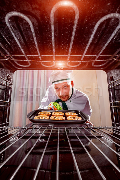 Chef cooking in the oven. Stock photo © cookelma