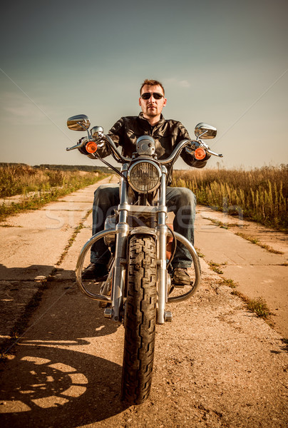 Biker in a leather jacket riding a motorcycle on the road Stock photo © cookelma