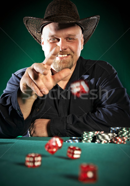 man throws dice on a green background Stock photo © cookelma