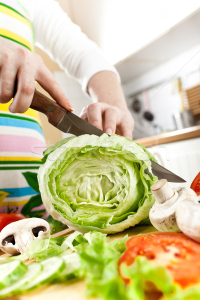 Stock photo: Woman's hands cutting vegetables