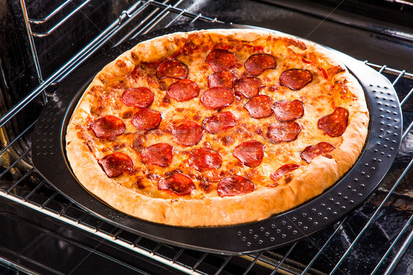 Pepperoni pizza in the oven. Stock photo © cookelma