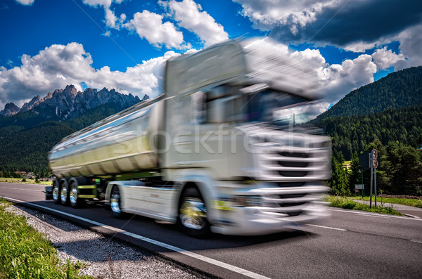 Fuel truck rushes down the highway in the background the Alps. T Stock photo © cookelma