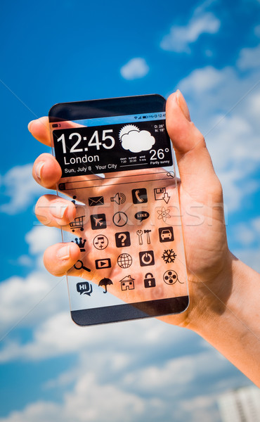 Stock photo: Smartphone with transparent screen in human hands.