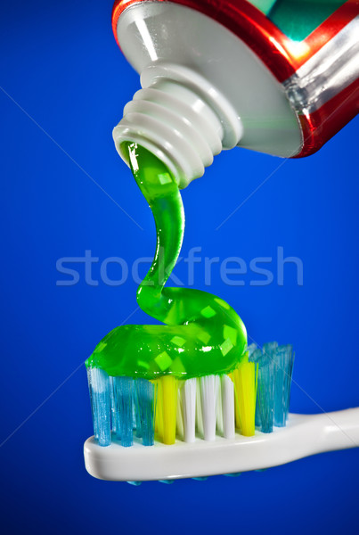 toothpaste being squeezed onto a toothbrush Stock photo © cookelma