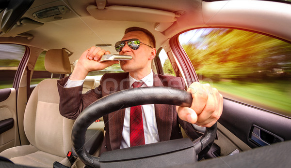 Drunk man driving a car vehicle. Stock photo © cookelma