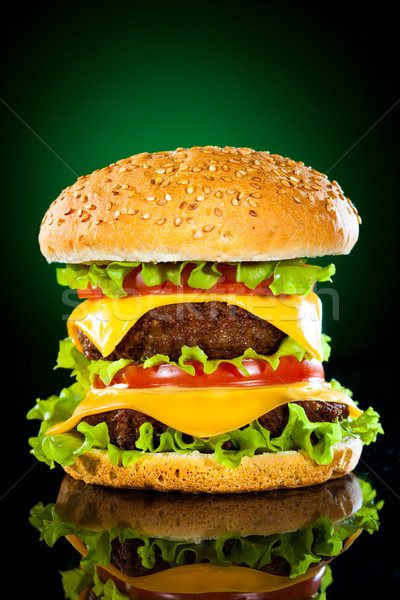 Tasty and appetizing hamburger on a darkly green Stock photo © cookelma