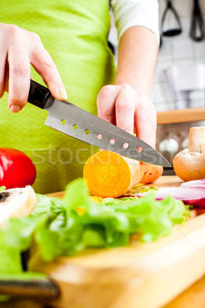 Stock photo: Woman's hands cutting vegetables