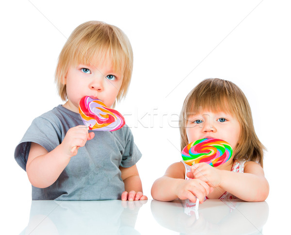 Neonati mangiare lollipop bianco mano sorriso Foto d'archivio © cookelma