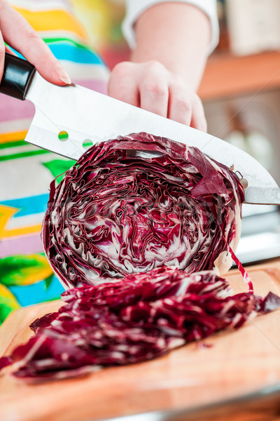 Stock photo: Woman's hands cutting red cabbage