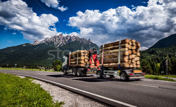Timber truck rushes down the highway in the background the Alps. Stock photo © cookelma