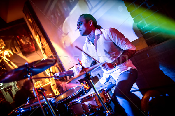 Drummer playing on drum set on stage. Stock photo © cookelma