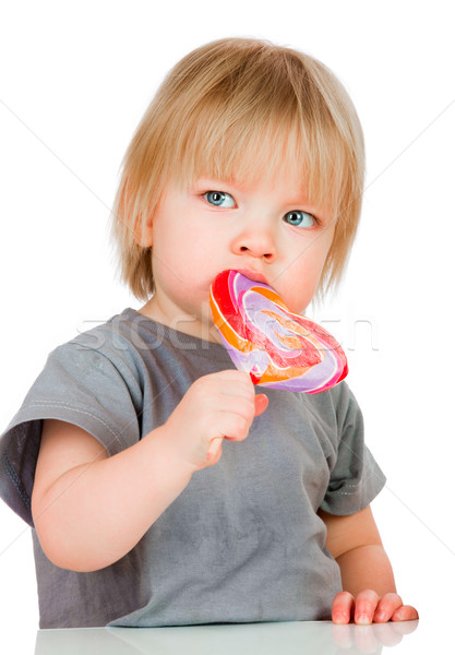 Baby eating a sticky lollipop Stock photo © cookelma