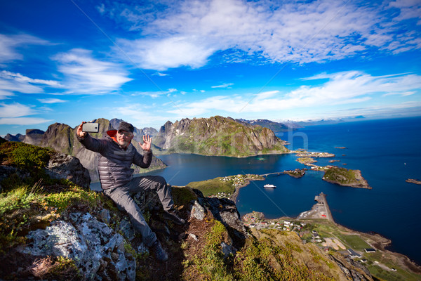 Man on top of a mountain taking a selfie Stock photo © cookelma