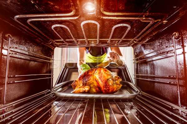 Cooking chicken in the oven at home. Stock photo © cookelma