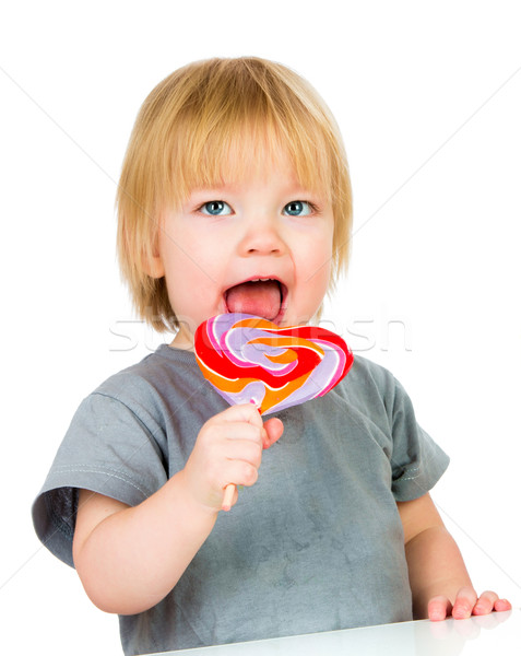 Baby eating a sticky lollipop Stock photo © cookelma