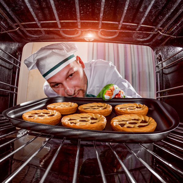 Chef cooking in the oven. Stock photo © cookelma