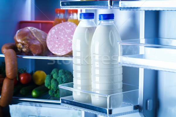 Otwarte lodówce żywności skupić butelek mleka Zdjęcia stock © cookelma