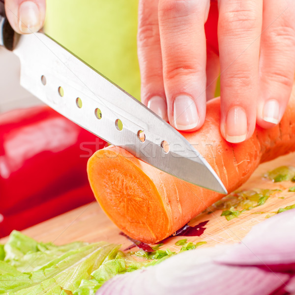 Stock photo: Woman's hands cutting vegetables