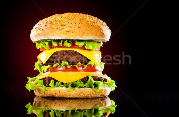 Tasty and appetizing hamburger on a darkly red Stock photo © cookelma