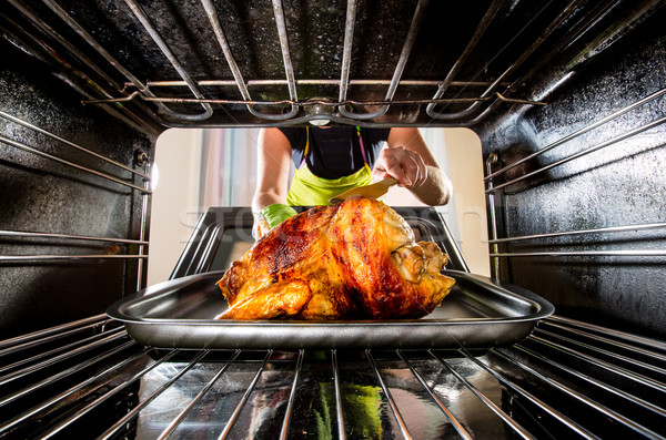 Cooking chicken in the oven at home. Stock photo © cookelma