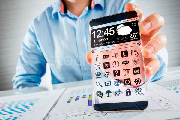 Stock photo: Smartphone with transparent screen in human hands.