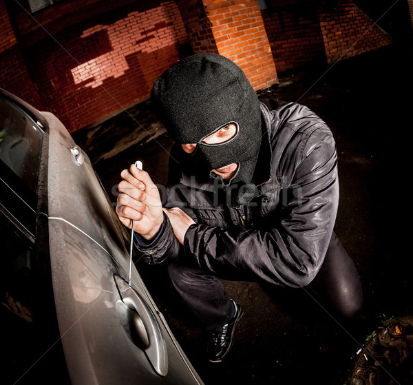 Car thief in a mask. Stock photo © cookelma