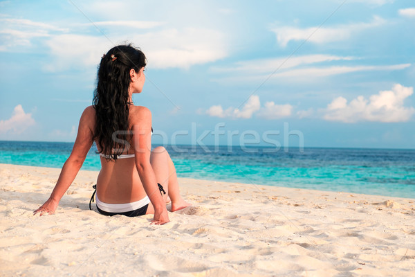 Girl walking along a tropical beach in the Maldives. Stock photo © cookelma