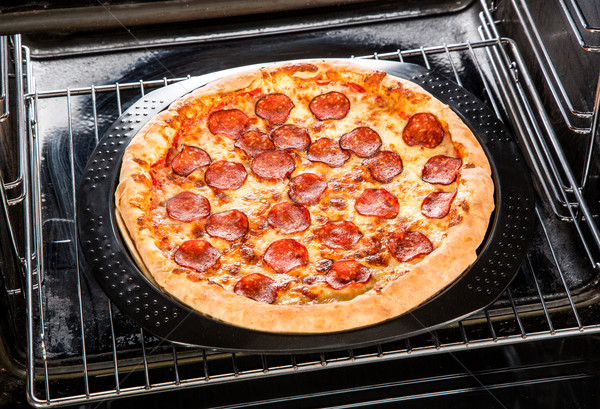 Pepperoni pizza in the oven. Stock photo © cookelma