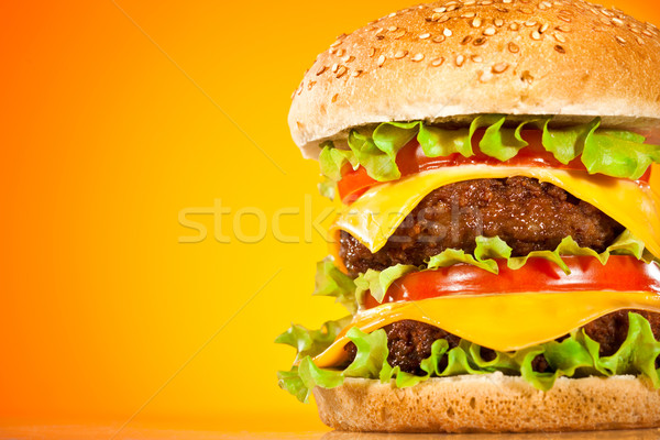 Tasty and appetizing hamburger on a yellow Stock photo © cookelma