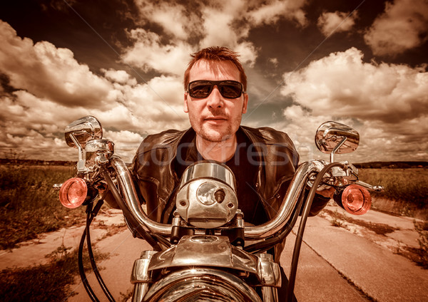 Stock photo: Biker on a motorcycle