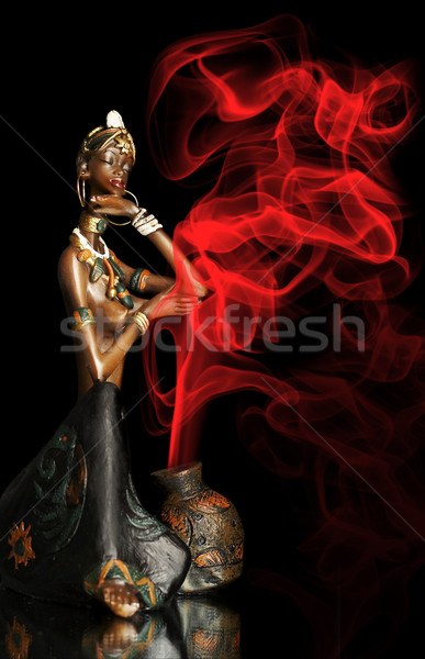  Figurine of the African girl on a black background Stock photo © cookelma