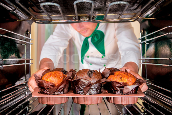 Baking muffins in the oven Stock photo © cookelma