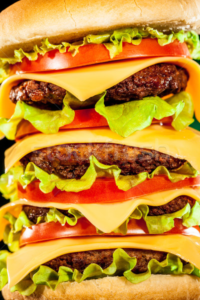 Tasty and appetizing hamburger on a dark Stock photo © cookelma