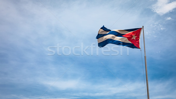 Cuban flag flying in the wind on a backdrop of blue sky. Stock photo © cookelma