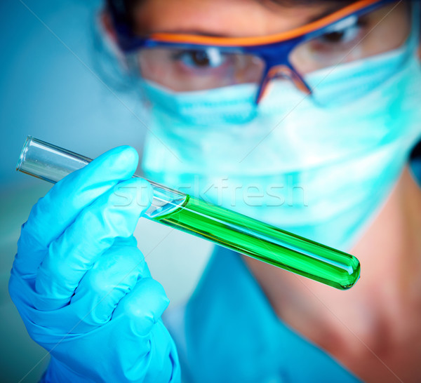 Stock photo: scientist in laboratory with test tubes 