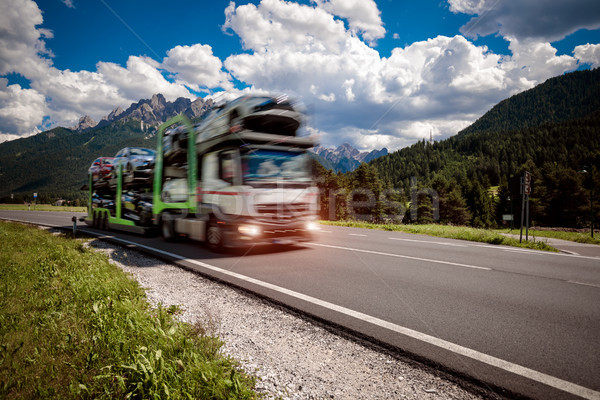 Stock photo: Truck trailer transports new cars rides on highway