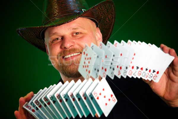 man skilfully shuffles playing cards Stock photo © cookelma
