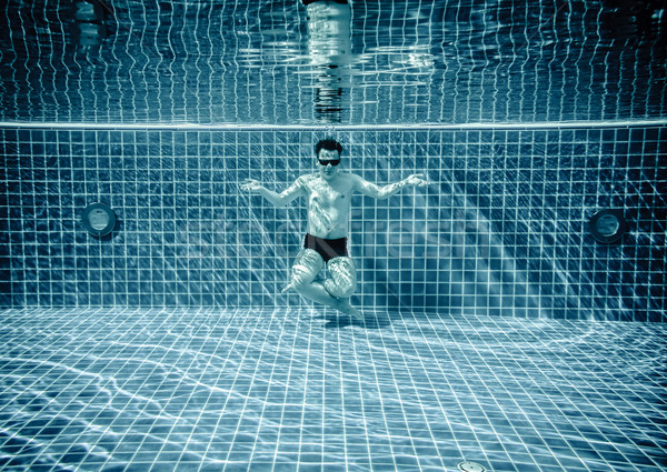 Persons lies under water in a swimming pool Stock photo © cookelma