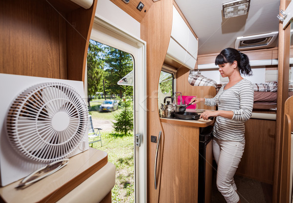 Woman cooking in camper, motorhome RV interior Stock photo © cookelma