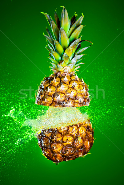 Pineapple splashed with water Stock photo © cookelma