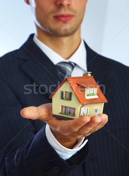 Hand of the businessman with the house Stock photo © cookelma