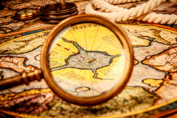 Vintage magnifying glass lies on the ancient map of the North Po Stock photo © cookelma
