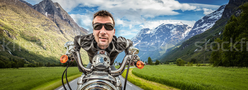 Funny Biker in sunglasses and leather jacket racing on mountain  Stock photo © cookelma
