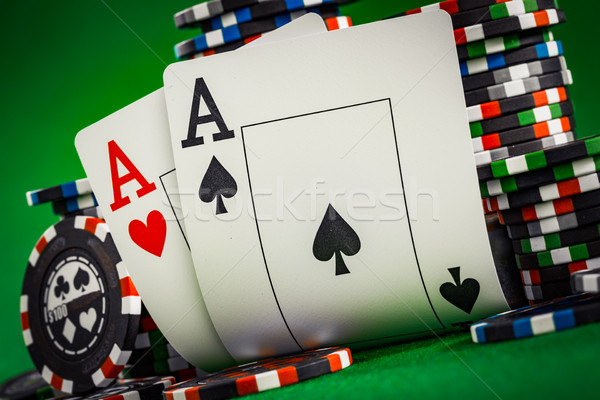Stack of chips and two aces on the table on the green baize Stock photo © cookelma